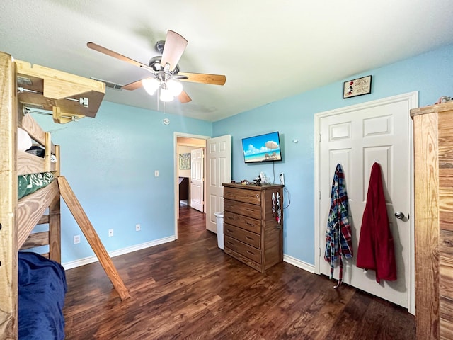 bedroom featuring ceiling fan and dark wood-type flooring