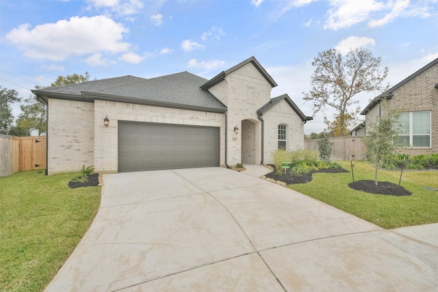 view of front of house with a front lawn and a garage