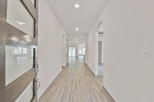 corridor with light wood-type flooring