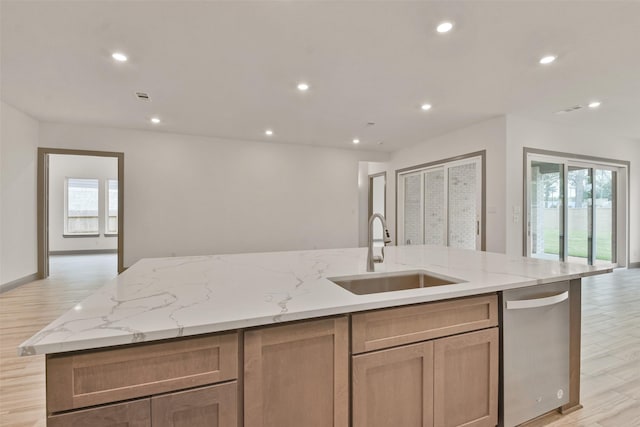 kitchen with a spacious island, light hardwood / wood-style flooring, a healthy amount of sunlight, and sink