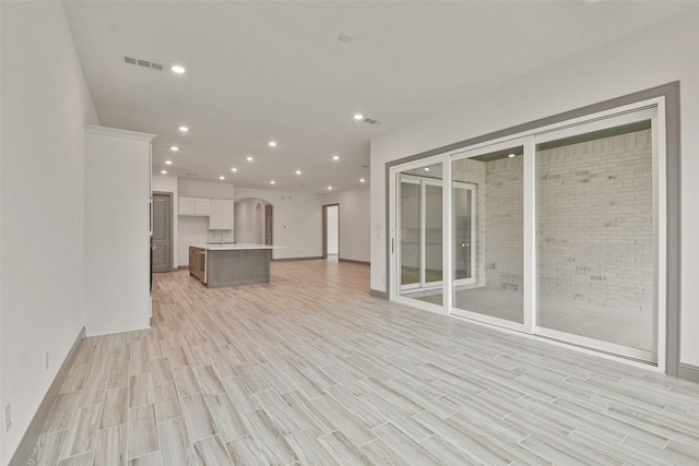 unfurnished living room featuring light hardwood / wood-style floors