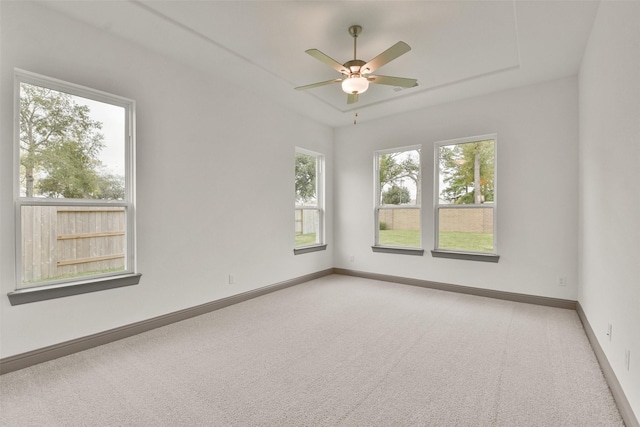 carpeted spare room with ceiling fan