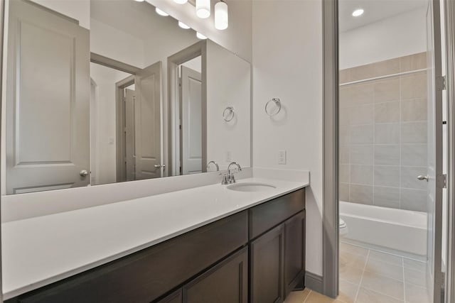 full bathroom featuring tile patterned flooring, vanity, toilet, and tiled shower / bath