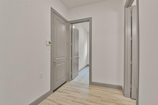 hallway with light hardwood / wood-style flooring