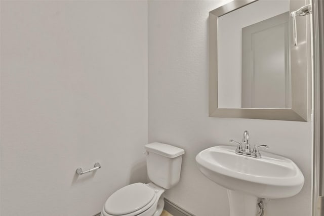 bathroom featuring toilet and sink