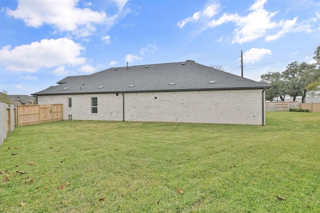 back of house featuring a lawn