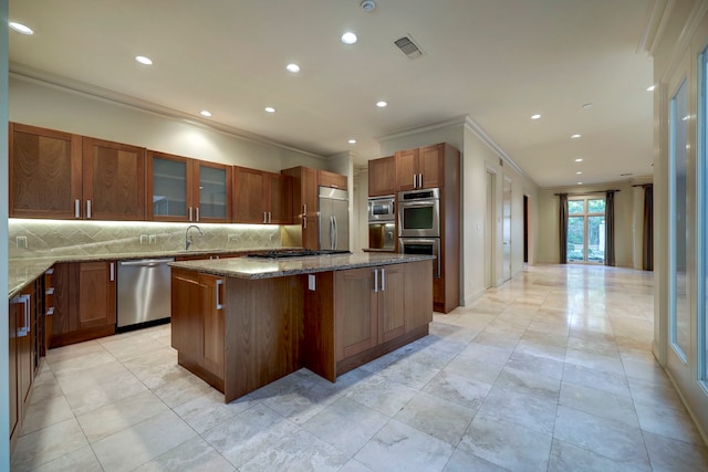 kitchen with built in appliances, a breakfast bar, light stone counters, a kitchen island, and decorative backsplash