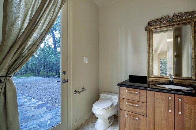 bathroom featuring vanity, toilet, and tile patterned floors