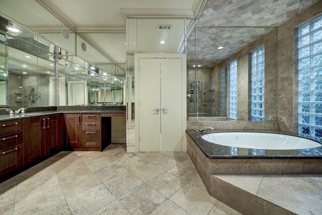 bathroom featuring tile patterned flooring, separate shower and tub, and vanity