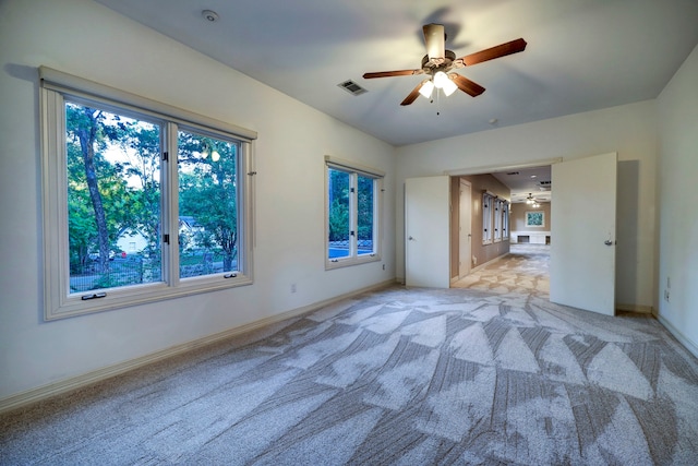 unfurnished bedroom featuring light carpet and ceiling fan