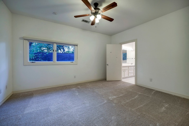 empty room with light colored carpet and ceiling fan