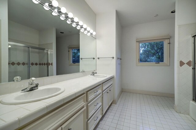 bathroom with dual vanity and tile patterned floors