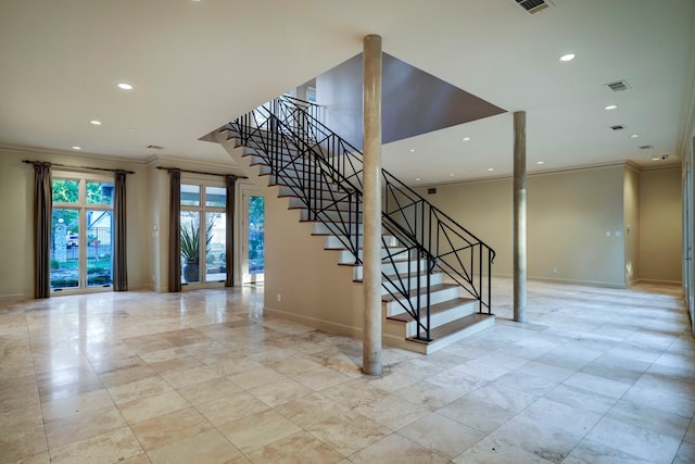 stairway with light tile patterned floors and crown molding