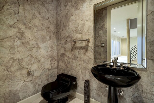 bathroom with tile patterned flooring and toilet