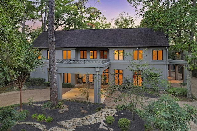 view of back house at dusk