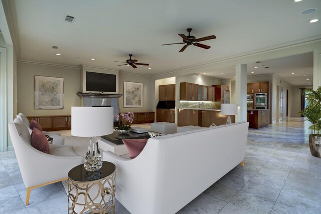 living room with ceiling fan, ornamental molding, and light tile patterned floors