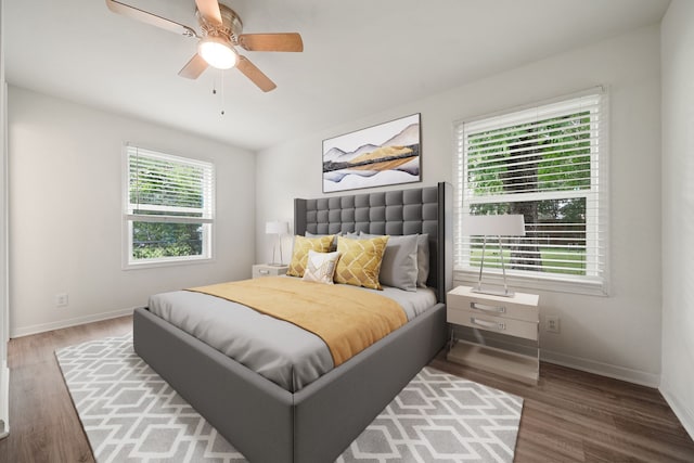 bedroom with ceiling fan and dark wood-type flooring