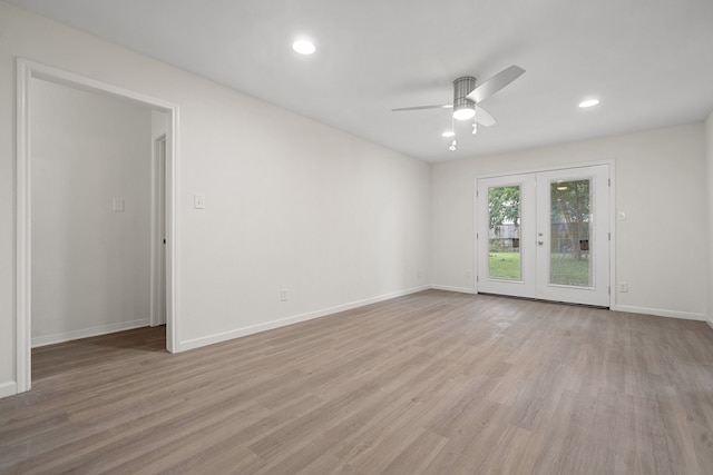 spare room featuring ceiling fan, french doors, and light wood-type flooring