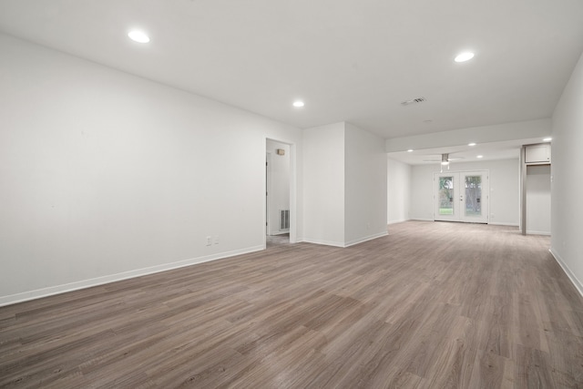 unfurnished living room featuring french doors and hardwood / wood-style flooring