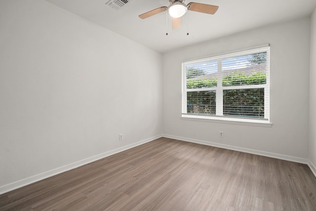 empty room with light hardwood / wood-style floors and ceiling fan