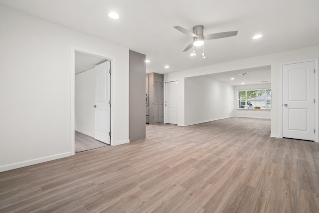 unfurnished living room with ceiling fan and light hardwood / wood-style floors