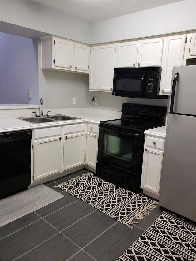 kitchen with white cabinetry, sink, and black appliances