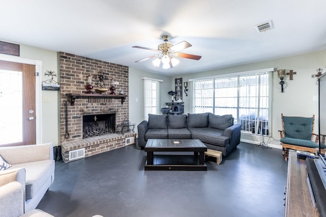 living area with concrete flooring, a wealth of natural light, and visible vents