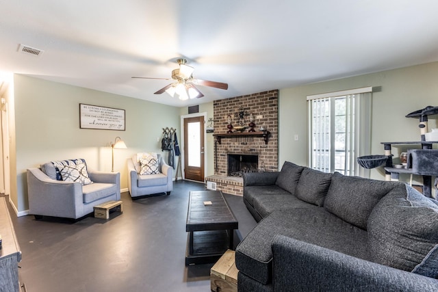 living area featuring ceiling fan, concrete floors, visible vents, baseboards, and a brick fireplace