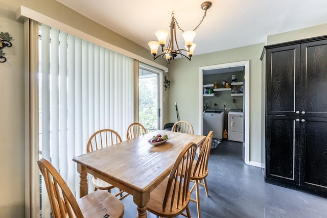 dining space featuring finished concrete flooring, an inviting chandelier, baseboards, and independent washer and dryer