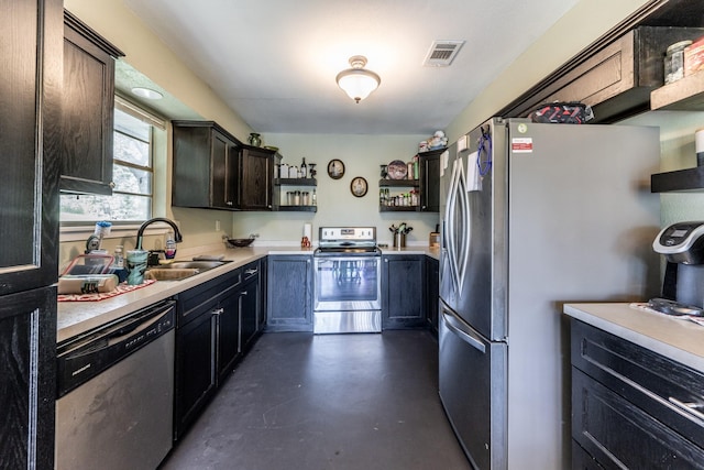 kitchen with visible vents, appliances with stainless steel finishes, light countertops, open shelves, and a sink