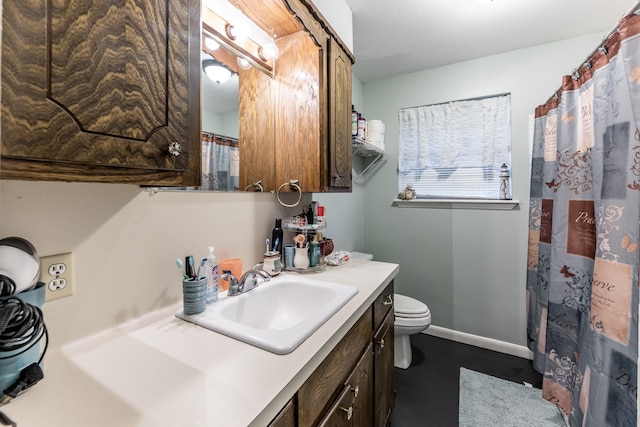 full bath featuring toilet, baseboards, and vanity