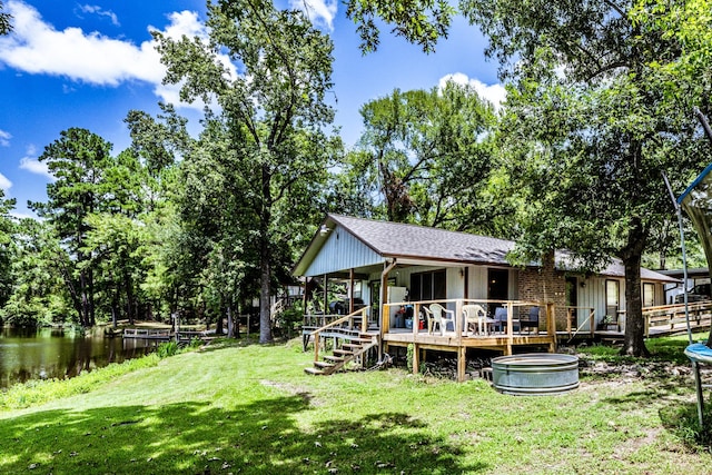 view of yard featuring a deck with water view