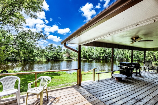 view of dock featuring a lawn and a deck with water view