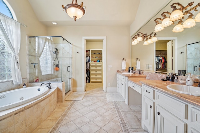 bathroom featuring separate shower and tub, lofted ceiling, tile patterned flooring, and double vanity