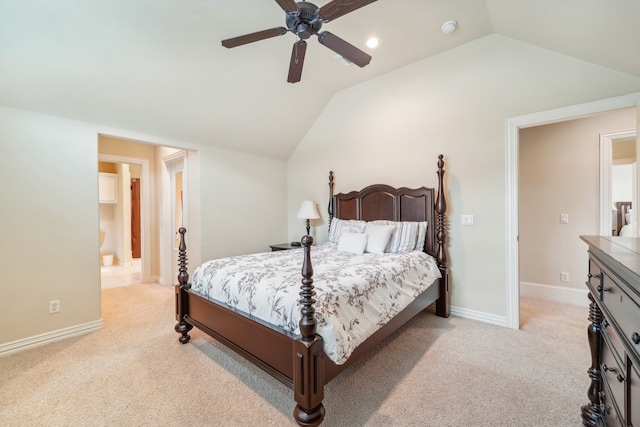 carpeted bedroom with connected bathroom, vaulted ceiling, and ceiling fan