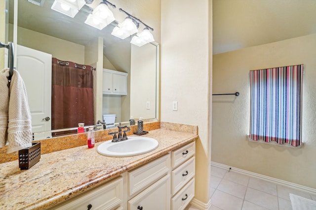 bathroom with tile patterned flooring, toilet, and vanity