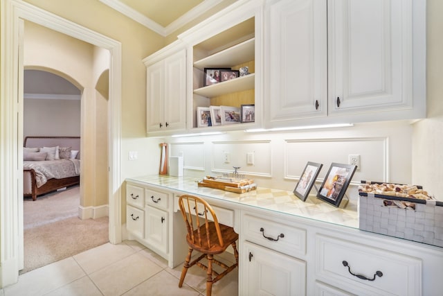 tiled office with crown molding and built in desk