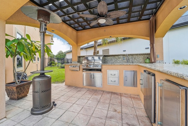 view of patio / terrace with a pergola, sink, ceiling fan, and area for grilling