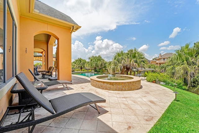 view of patio with a swimming pool with hot tub