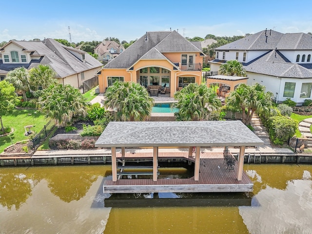 dock area featuring a patio and a water view