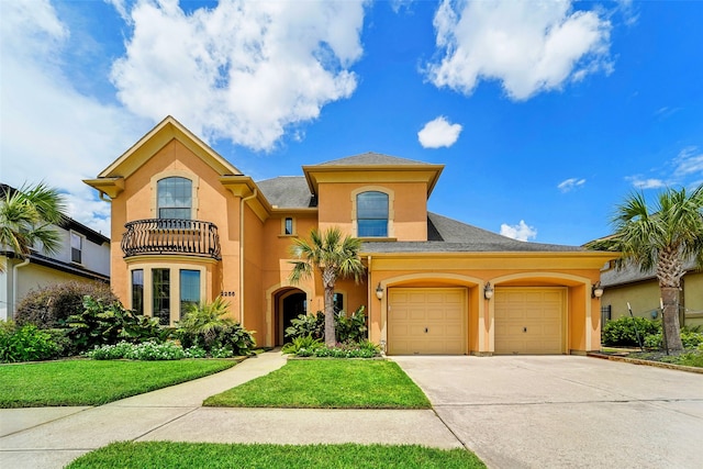 mediterranean / spanish home featuring a balcony, a garage, and a front lawn