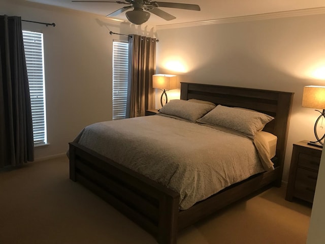 carpeted bedroom with ceiling fan and ornamental molding