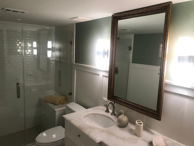 bathroom with vanity, toilet, and walk in shower