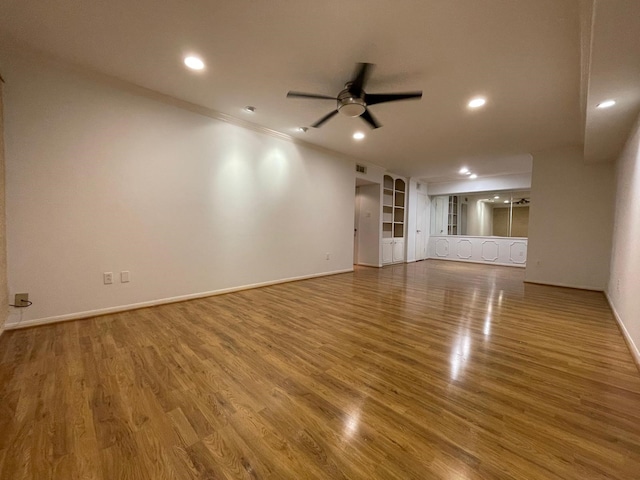 unfurnished living room with light hardwood / wood-style flooring and ceiling fan