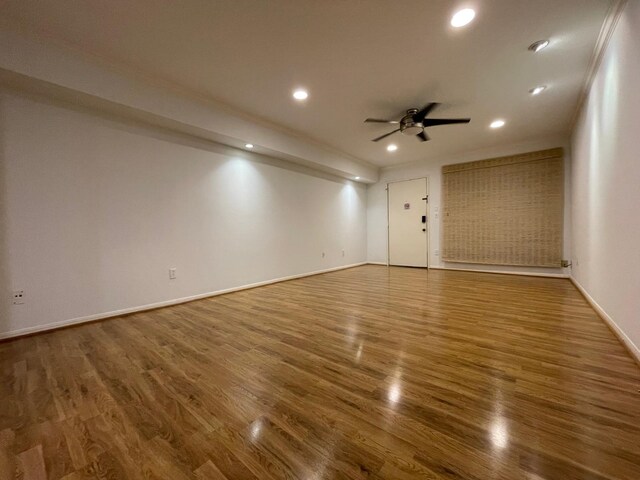 unfurnished room featuring ceiling fan and hardwood / wood-style flooring