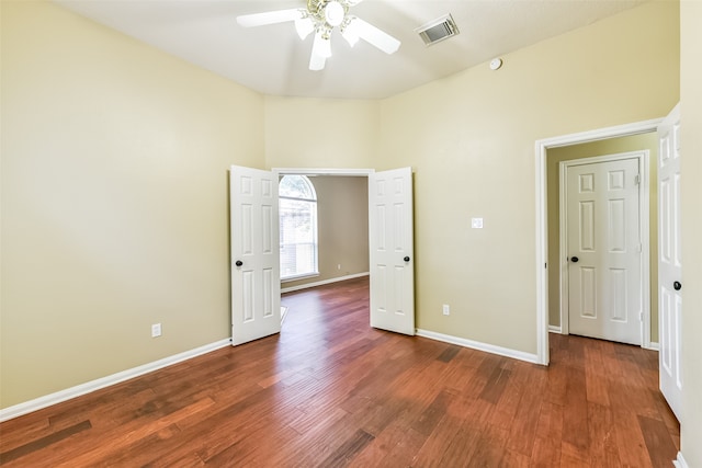 unfurnished bedroom featuring ceiling fan and dark hardwood / wood-style floors