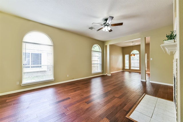 empty room with hardwood / wood-style flooring and ceiling fan