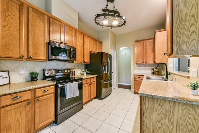 kitchen with tasteful backsplash, sink, light tile patterned floors, and stainless steel appliances