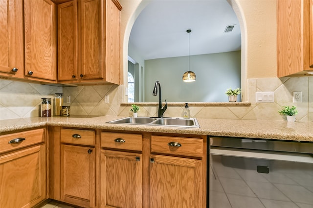 kitchen featuring decorative backsplash, tile patterned flooring, sink, stainless steel dishwasher, and decorative light fixtures