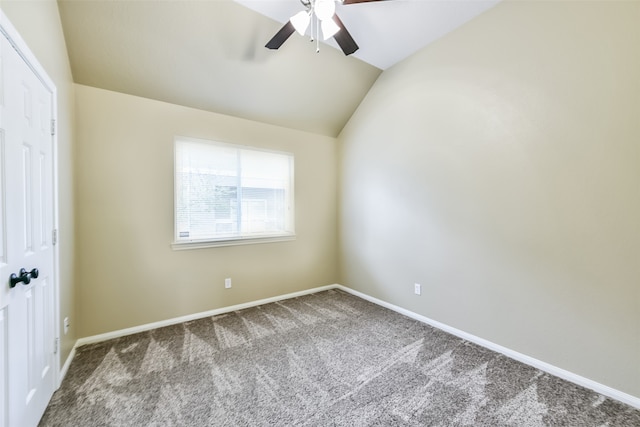 empty room with lofted ceiling and carpet floors